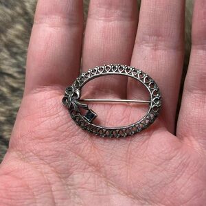 Round open sterling silver open work blue glass brooch